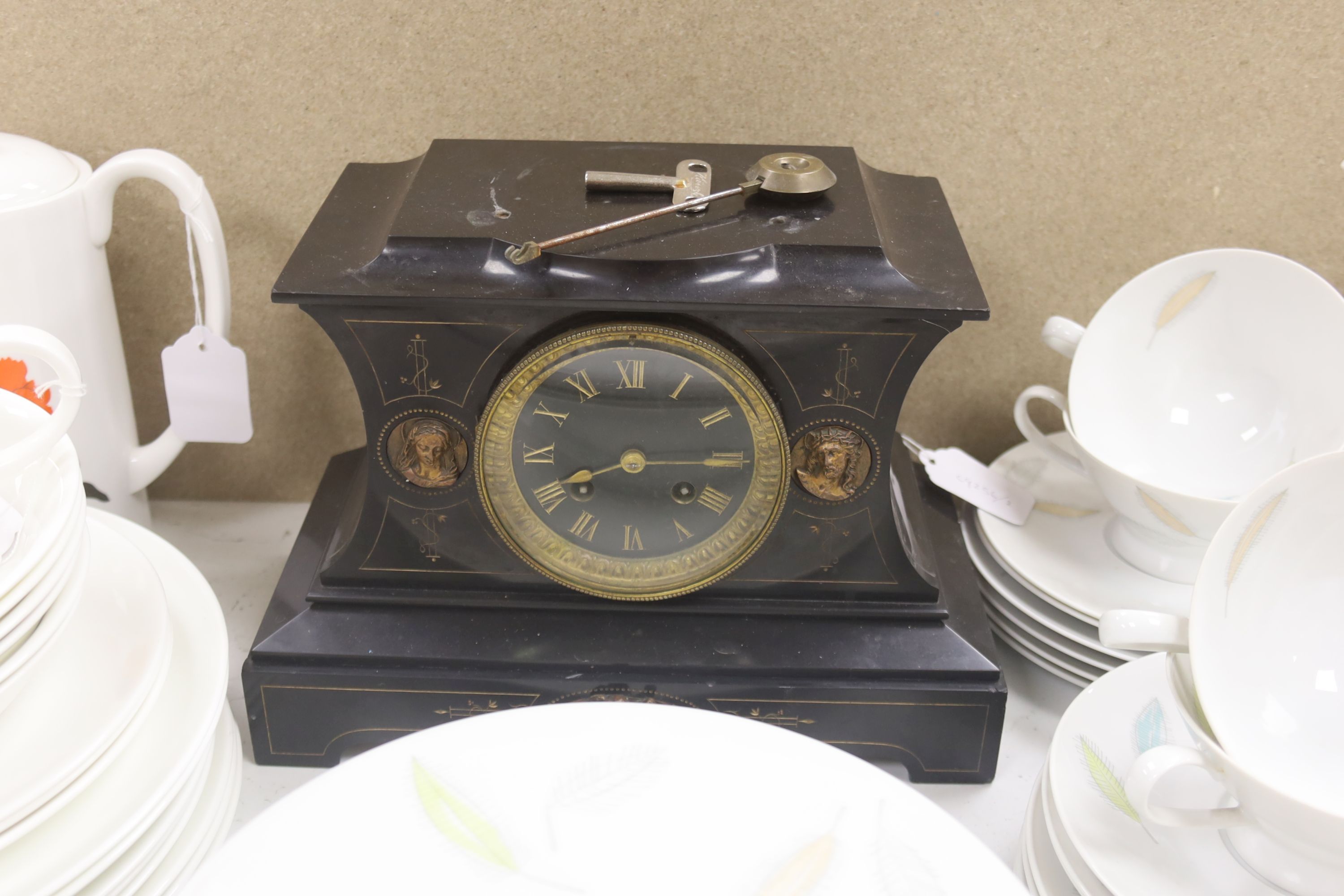An ecclesiastical black slate mantel clock, height 21cm